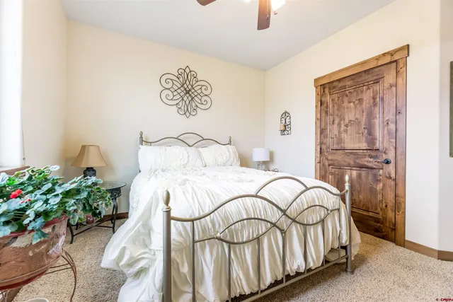a view of a hallway with wooden floor and living room