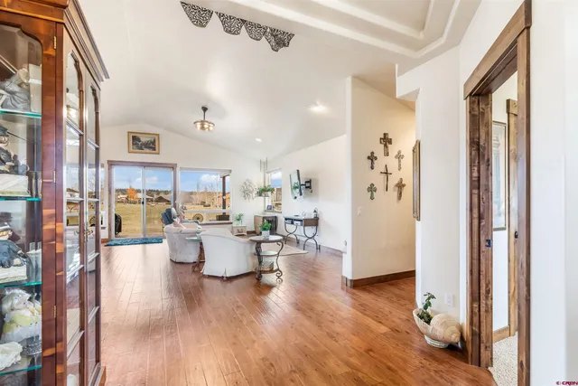 a living room with furniture or wooden floor and a large window