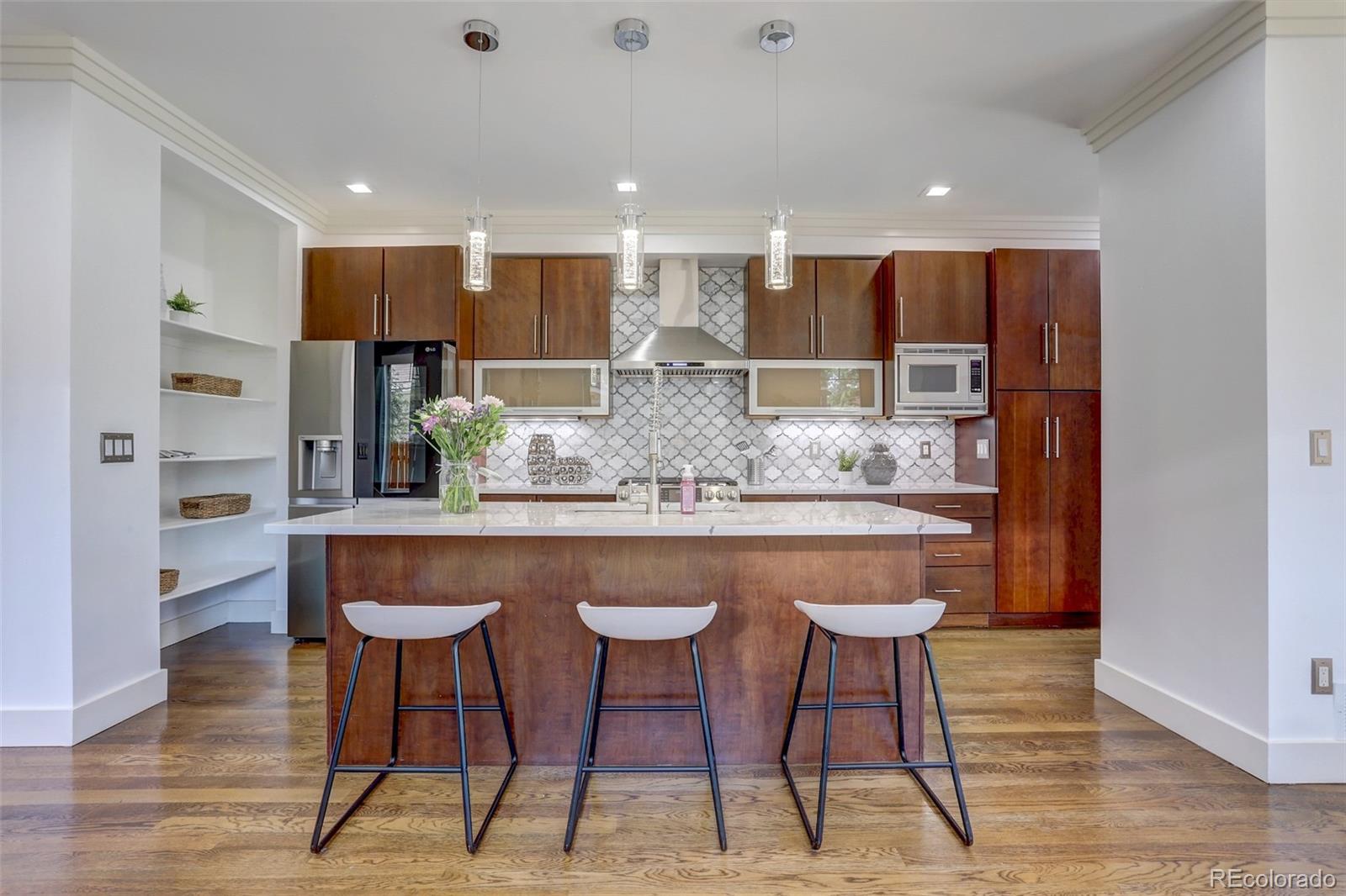 4238 Stuart Street Denver, CO 80212 - Photo 11 of 50 a kitchen with stainless steel appliances kitchen island granite countertop a kitchen island a white cabinets a sink and a white cabinets