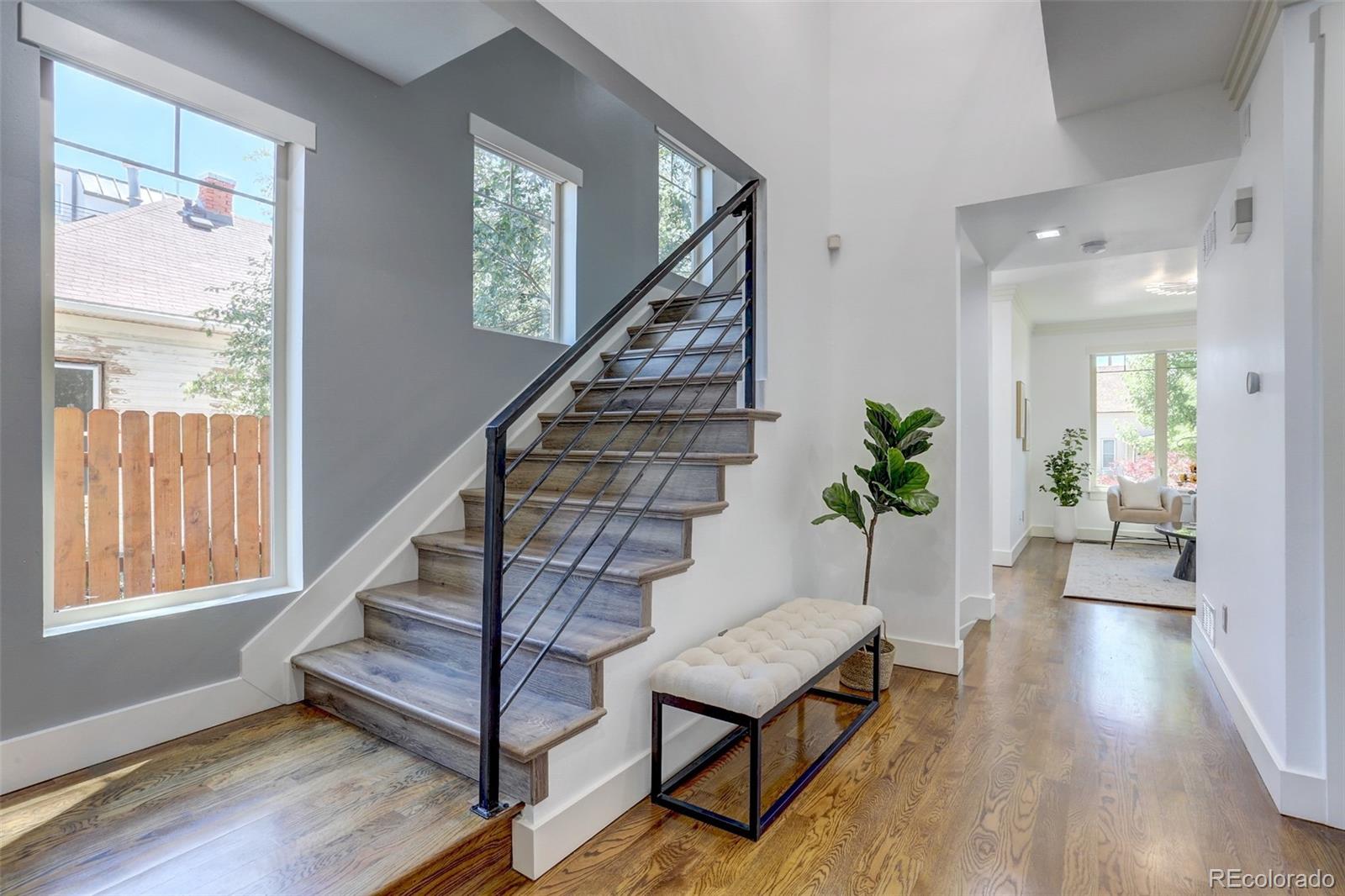 4238 Stuart Street Denver, CO 80212 - Photo 17 of 50 a view of an entryway with wooden floor and a potted plant
