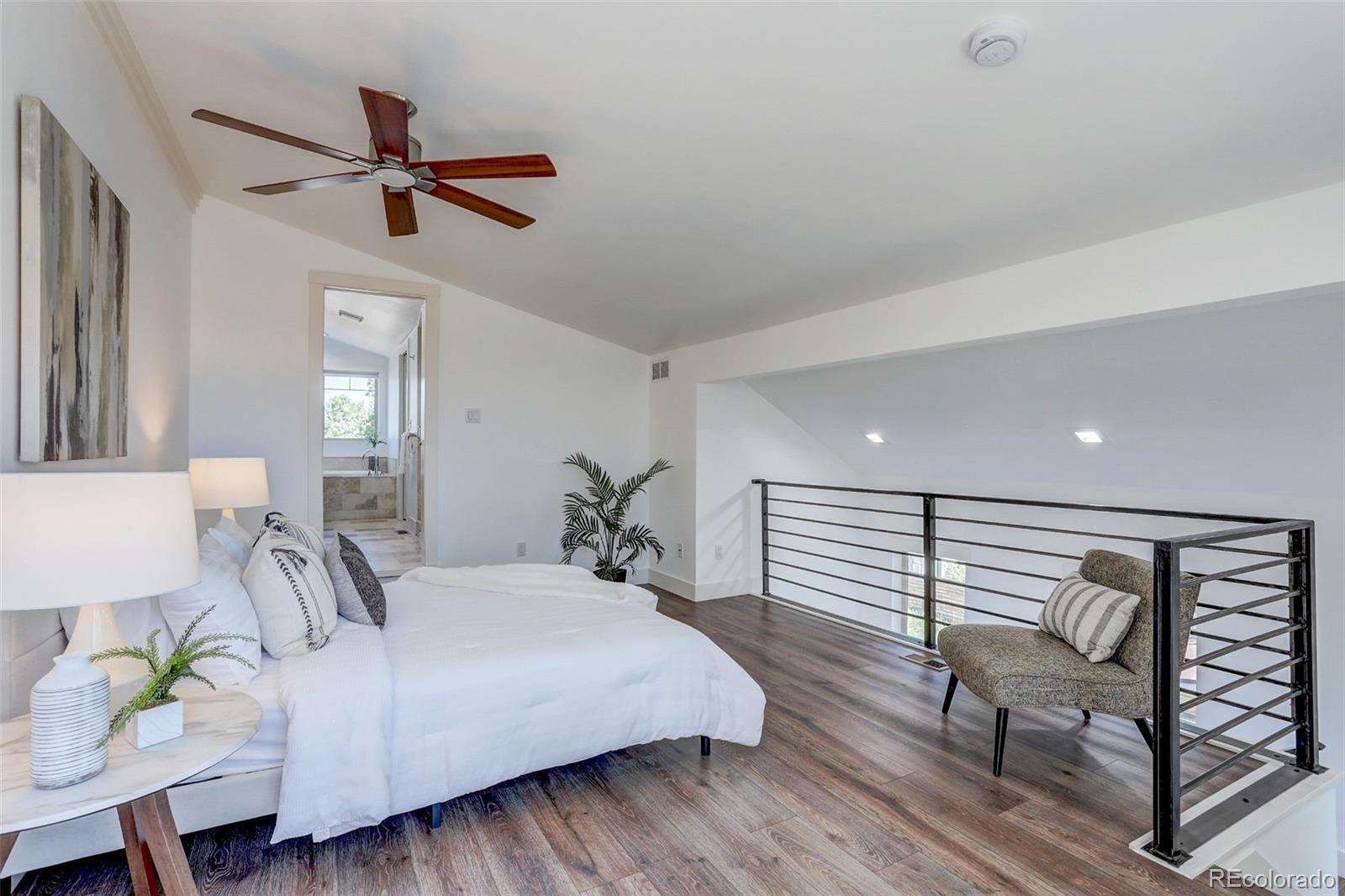 4238 Stuart Street Denver, CO 80212 - Photo 21 of 50 a bedroom with a bed and a chandelier