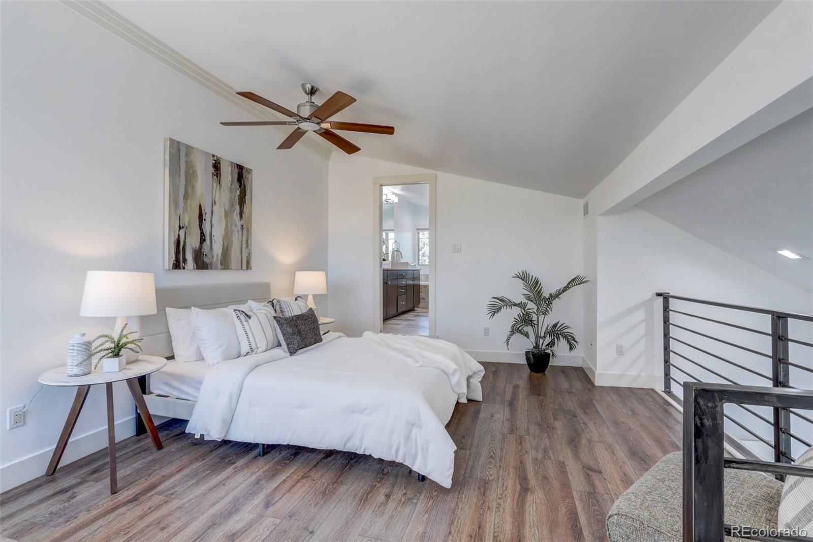 4238 Stuart Street Denver, CO 80212 - Photo 22 of 50 a bedroom with a bed and wooden floor