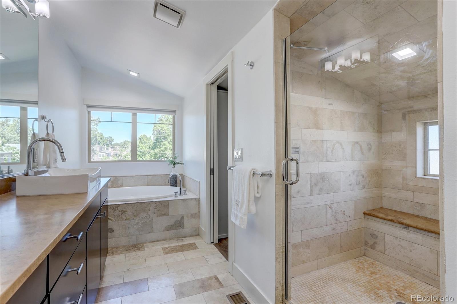 4238 Stuart Street Denver, CO 80212 - Photo 23 of 50 a bathroom with a granite countertop sink a toilet and shower