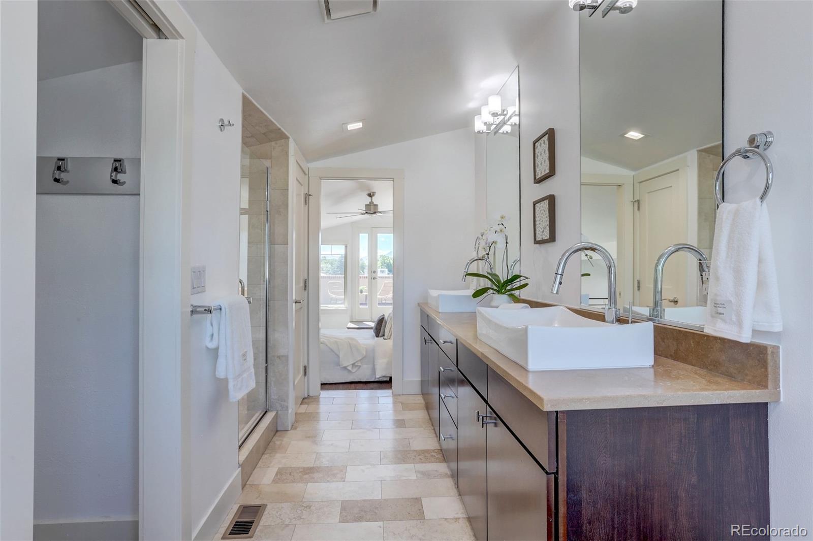 4238 Stuart Street Denver, CO 80212 - Photo 25 of 50 a bathroom with a double vanity sink a mirror and shower