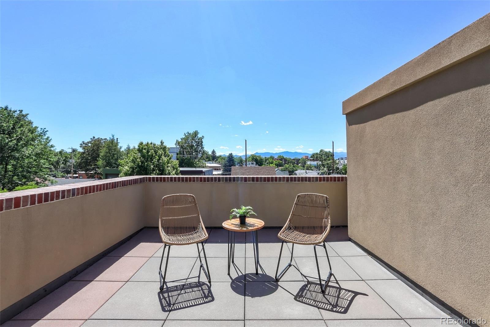 4238 Stuart Street Denver, CO 80212 - Photo 27 of 50 a balcony with table and chairs