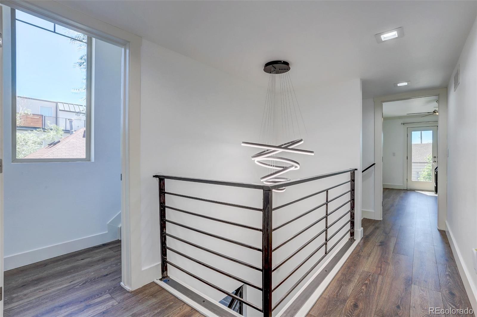 4238 Stuart Street Denver, CO 80212 - Photo 28 of 50 a view of a hallway with wooden floor and staircase
