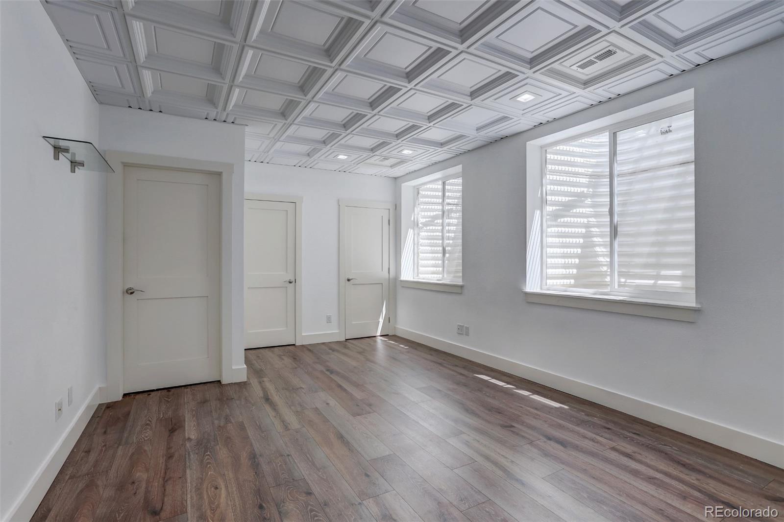 4238 Stuart Street Denver, CO 80212 - Photo 38 of 50 a view of an empty room with wooden floor and a window