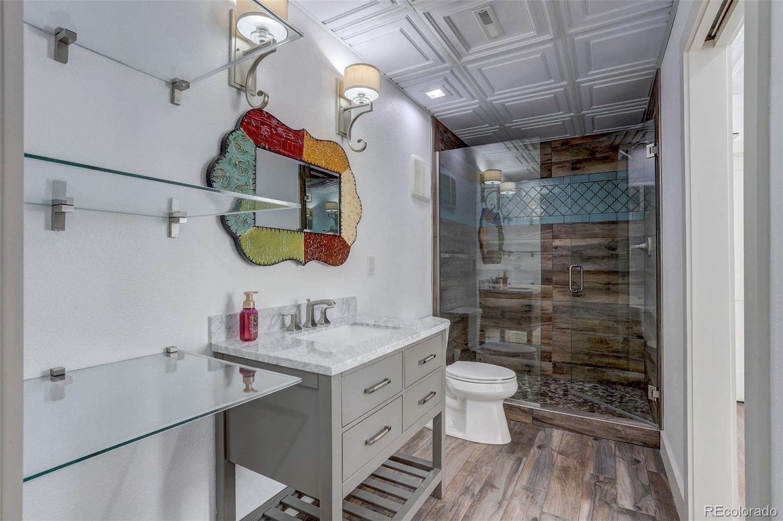 4238 Stuart Street Denver, CO 80212 - Photo 39 of 50 a bathroom with a sink vanity mirror and toilet
