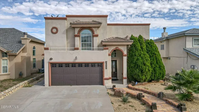 a front view of a house with plants