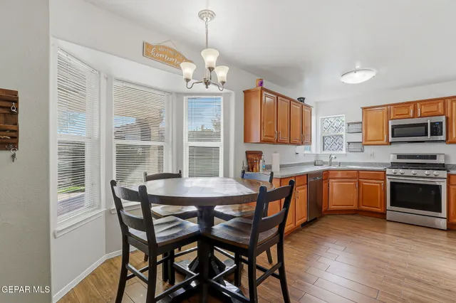 a kitchen with stainless steel appliances granite countertop a stove a microwave and a refrigerator