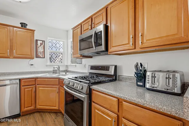 a dining room with furniture a chandelier and wooden floor