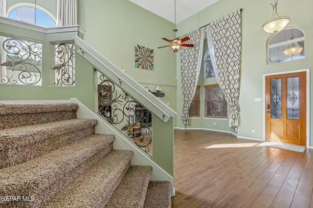 a bed room with a bed a television and a large window