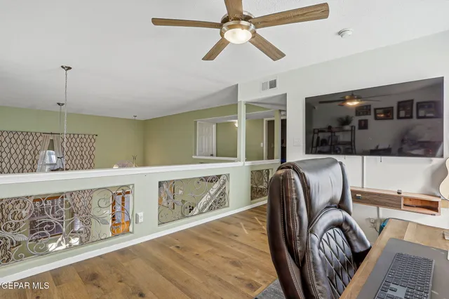 a bedroom with a bed and a tv on the dresser