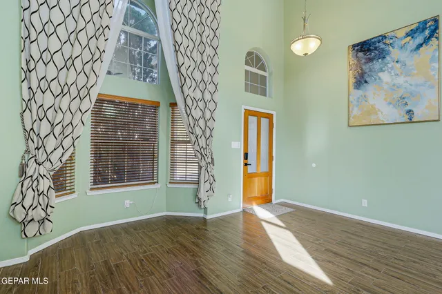 a view of an empty room with a fireplace and a window