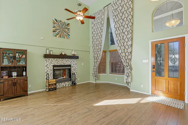 a view of hall way with wooden floor and chandelier