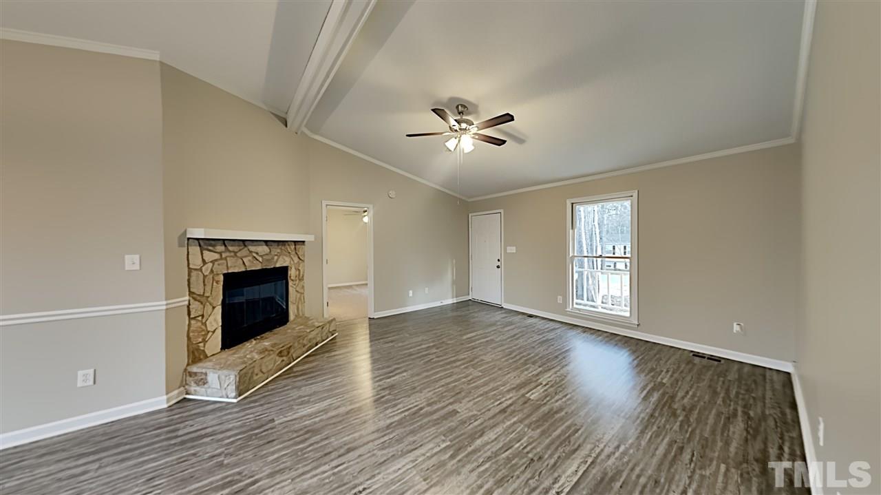 4225 Labrador Drive Raleigh, NC 27616 - Photo 2 of 13 wooden floor fireplace and windows in an empty room