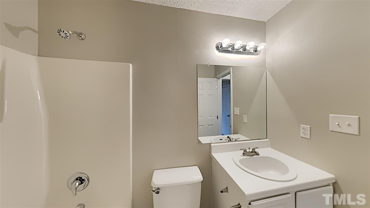 4225 Labrador Drive Raleigh, NC 27616 - Photo 12 of 13 a bathroom with a toilet a sink and a mirror