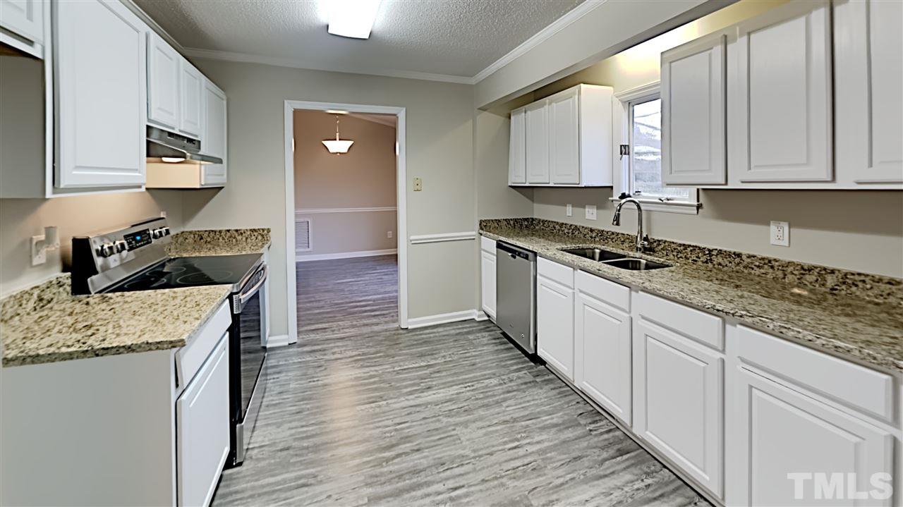 4225 Labrador Drive Raleigh, NC 27616 - Photo 5 of 13 a kitchen with granite countertop a sink and cabinets