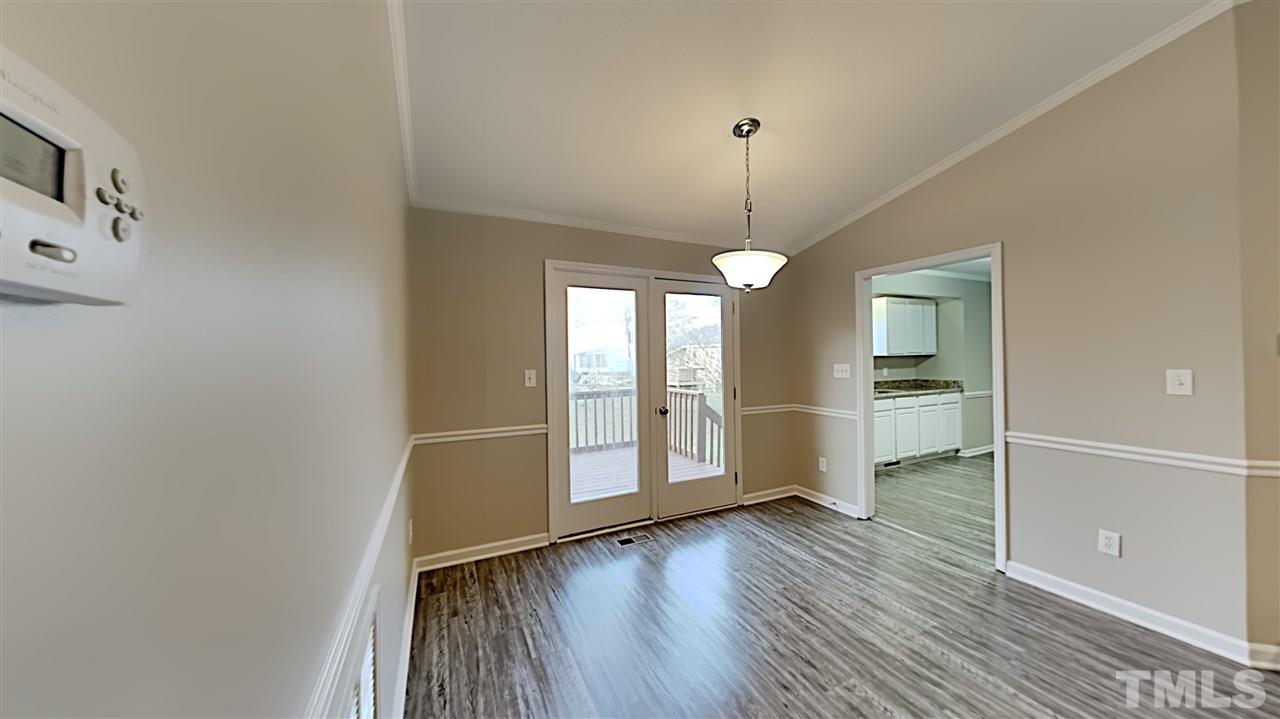 4225 Labrador Drive Raleigh, NC 27616 - Photo 6 of 13 a view of empty room with wooden floor and fan
