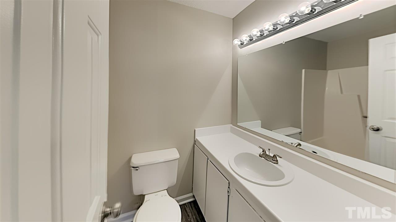 4225 Labrador Drive Raleigh, NC 27616 - Photo 9 of 13 a bathroom with a sink a toilet and mirror