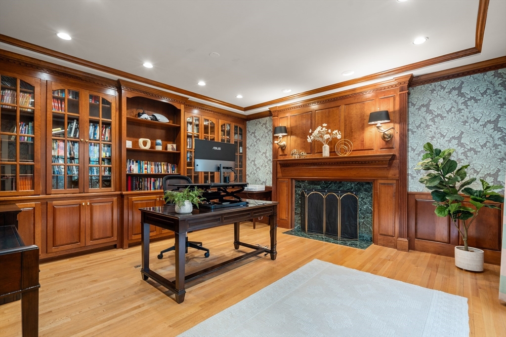 67 Bridle Path Sudbury, MA 01776 - Photo 11 of 42 a living room with furniture a fireplace and potted plants