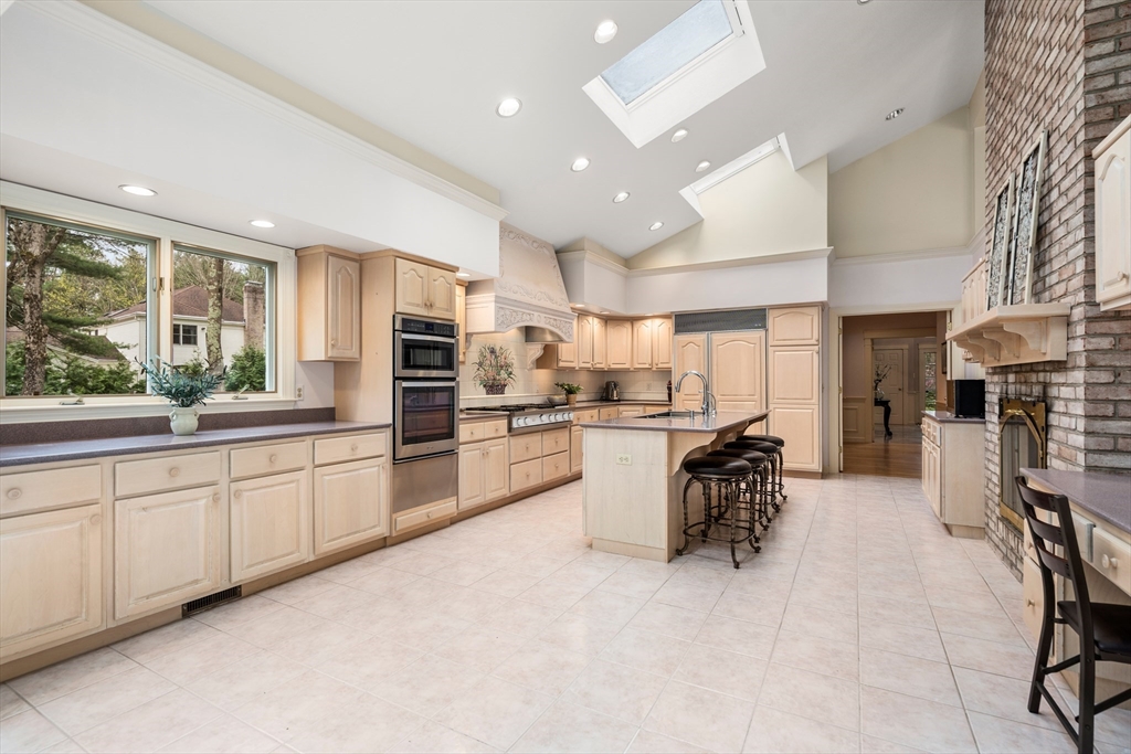 67 Bridle Path Sudbury, MA 01776 - Photo 12 of 42 a large white kitchen with lots of counter top space and stainless steel appliances