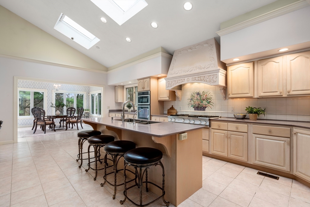 67 Bridle Path Sudbury, MA 01776 - Photo 15 of 42 a kitchen with cabinets and chairs
