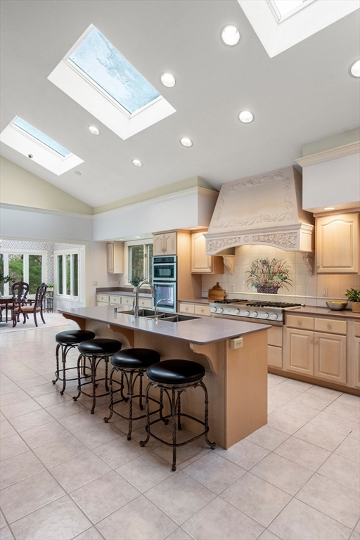 67 Bridle Path Sudbury, MA 01776 - Photo 16 of 42 a kitchen with stainless steel appliances granite countertop a table chairs sink and cabinets