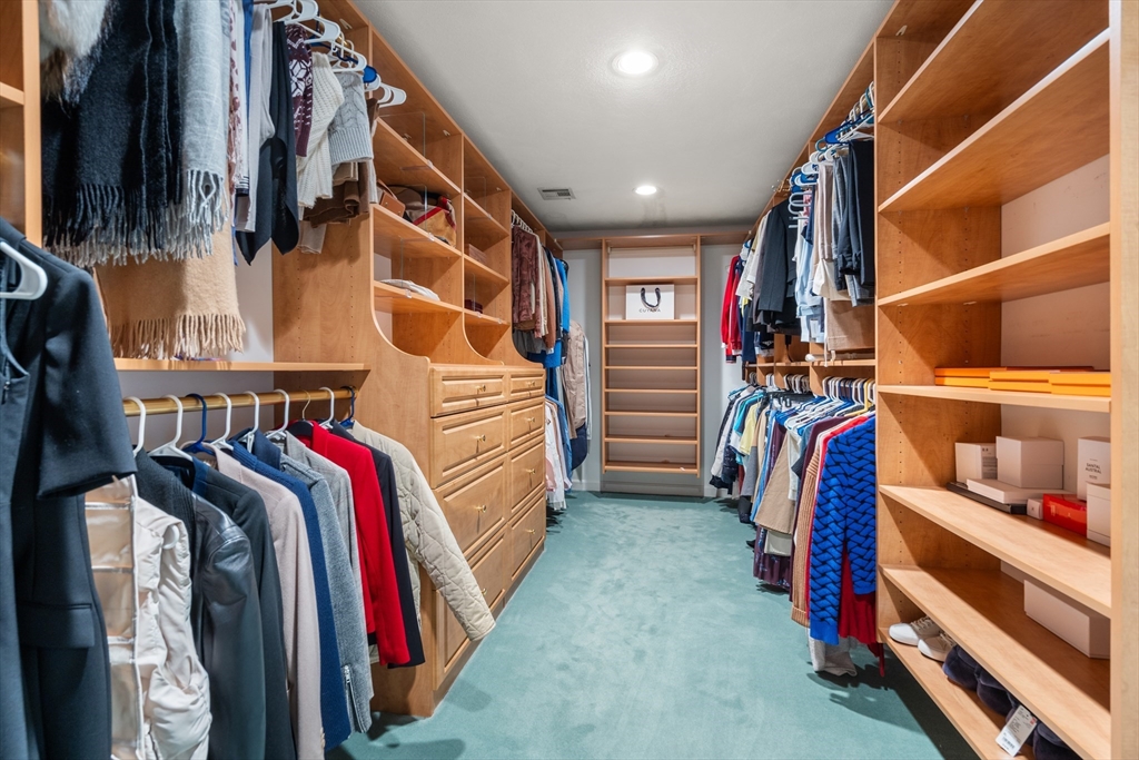 67 Bridle Path Sudbury, MA 01776 - Photo 23 of 42 a view of walk in closet with clothes and shoes