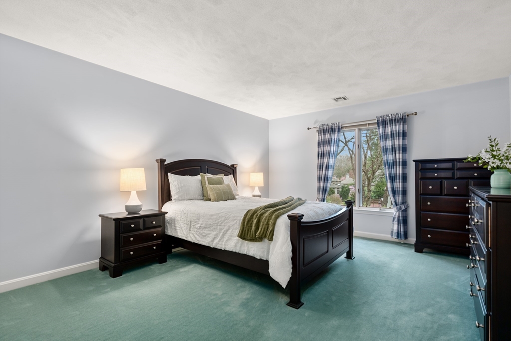 67 Bridle Path Sudbury, MA 01776 - Photo 24 of 42 a spacious bedroom with a bed and furniture