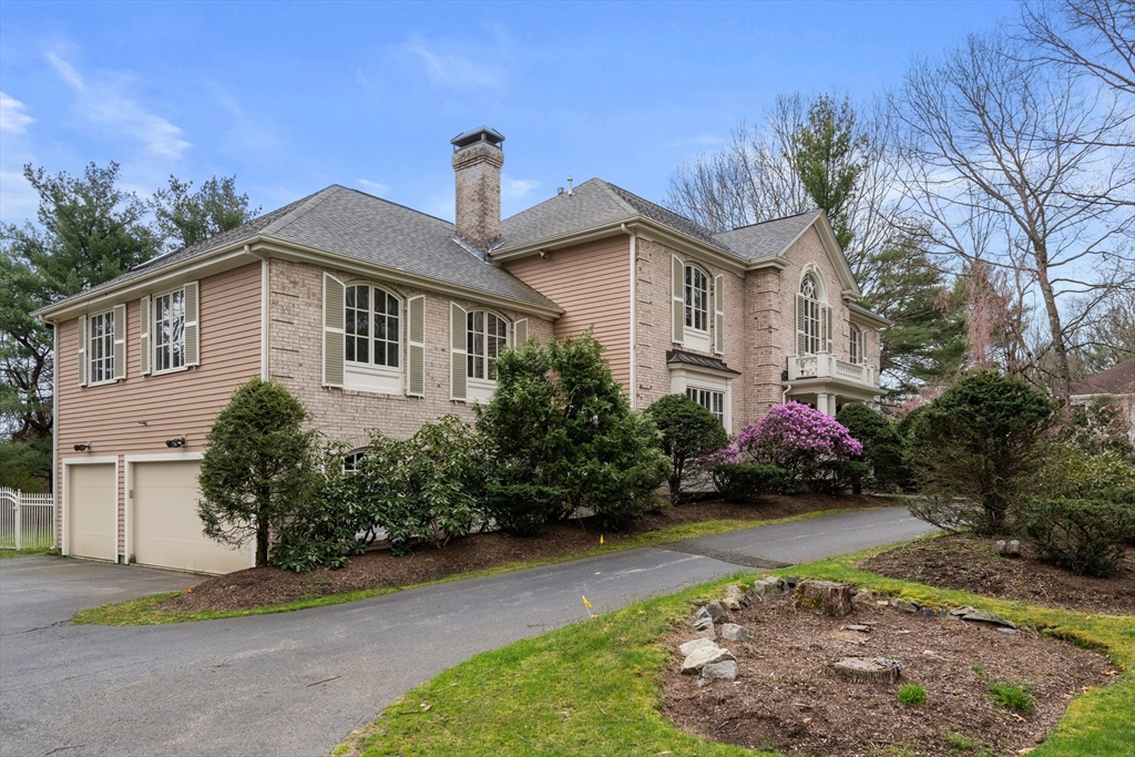 67 Bridle Path Sudbury, MA 01776 - Photo 37 of 42 a front view of a house with a garden