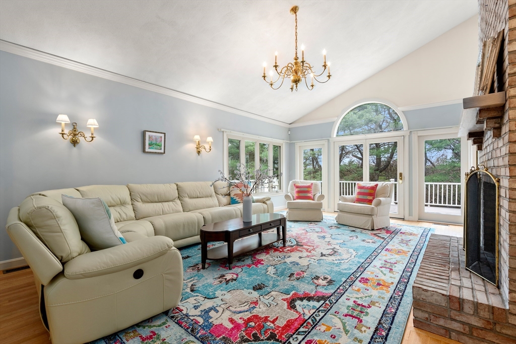 67 Bridle Path Sudbury, MA 01776 - Photo 5 of 42 a living room with furniture a chandelier and a rug