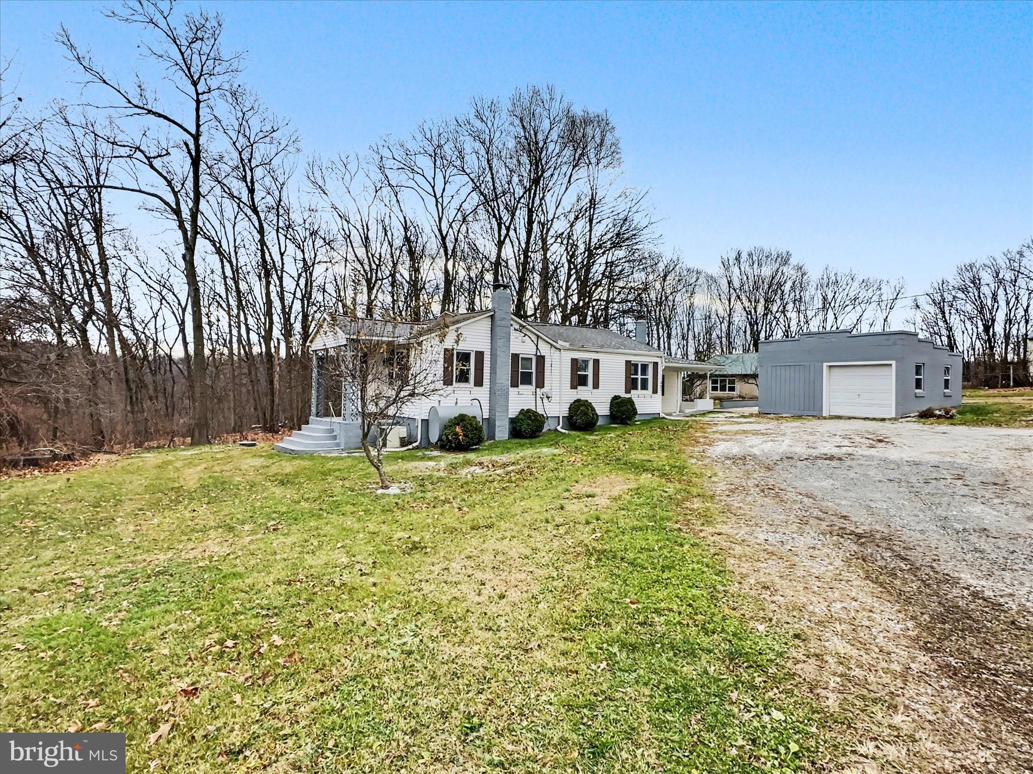 1063 Snyder Corner Road Red Lion, PA 17356 - Photo 2 of 23 a front view of a house with a yard table and chairs