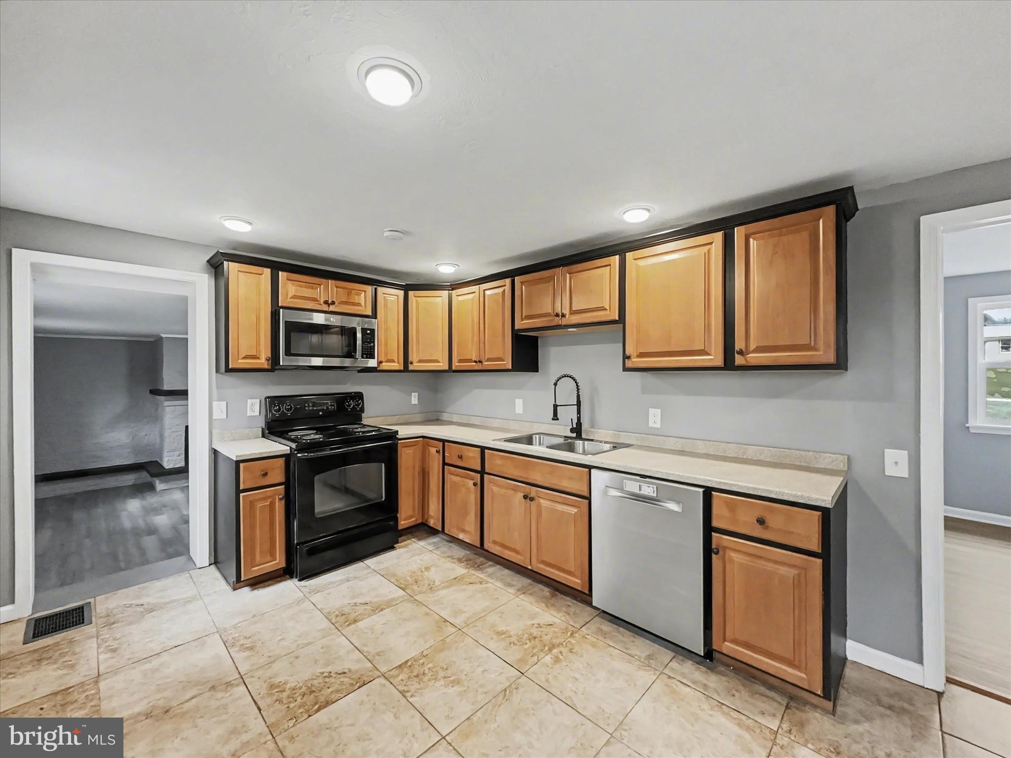 1063 Snyder Corner Road Red Lion, PA 17356 - Photo 6 of 23 a kitchen with stainless steel appliances granite countertop a stove sink and cabinets