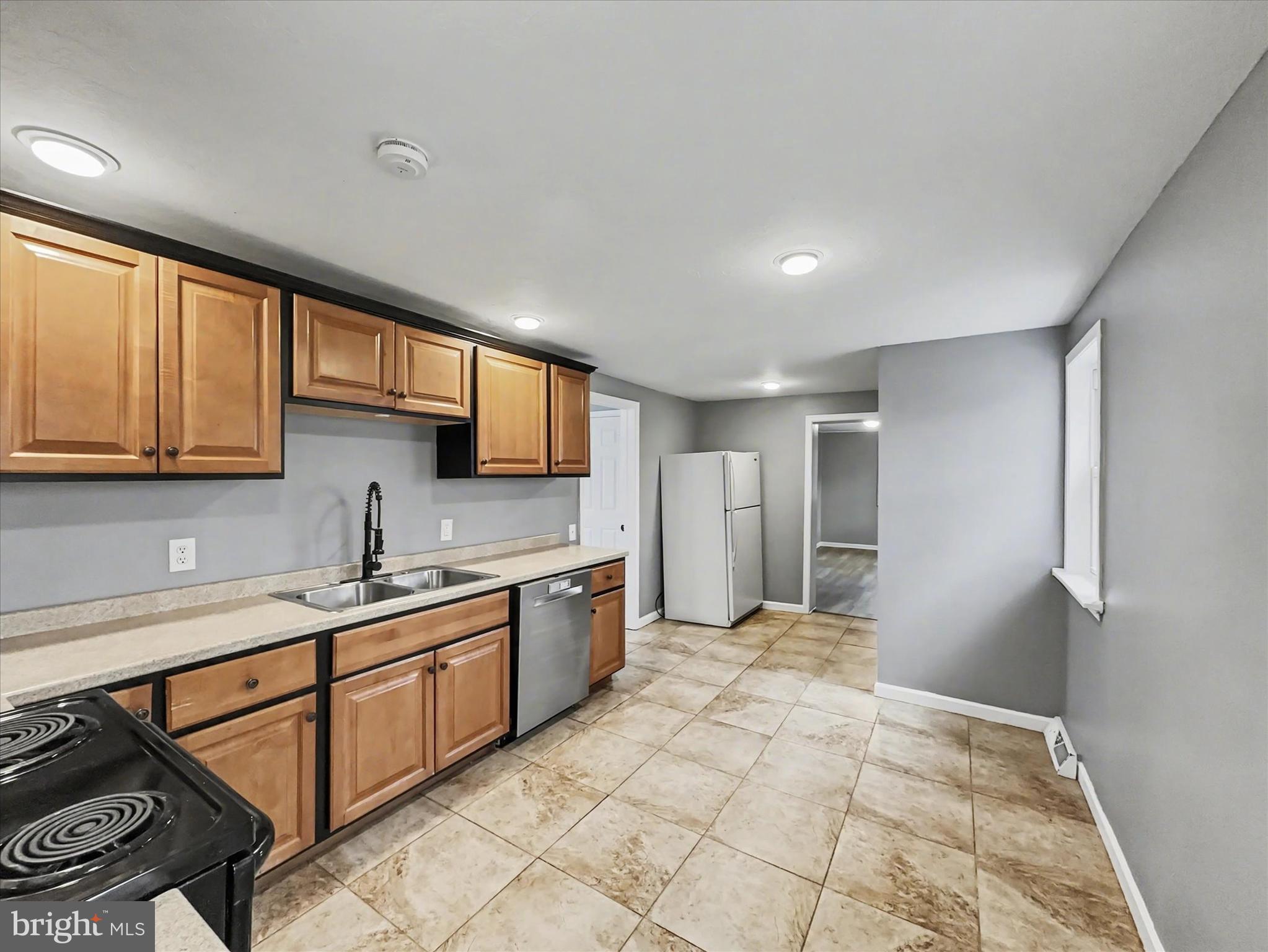 1063 Snyder Corner Road Red Lion, PA 17356 - Photo 7 of 23 a large kitchen with stainless steel appliances granite countertop a stove a sink and a refrigerator