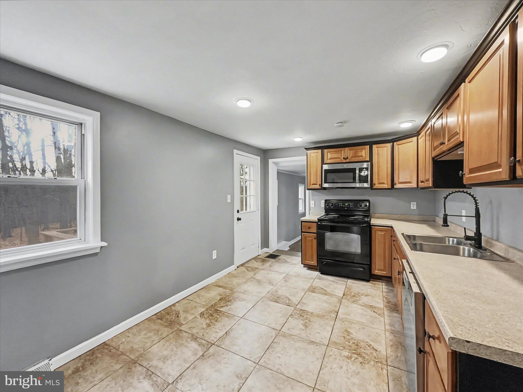 1063 Snyder Corner Road Red Lion, PA 17356 - Photo 8 of 23 a kitchen with stainless steel appliances granite countertop a stove a sink and a microwave