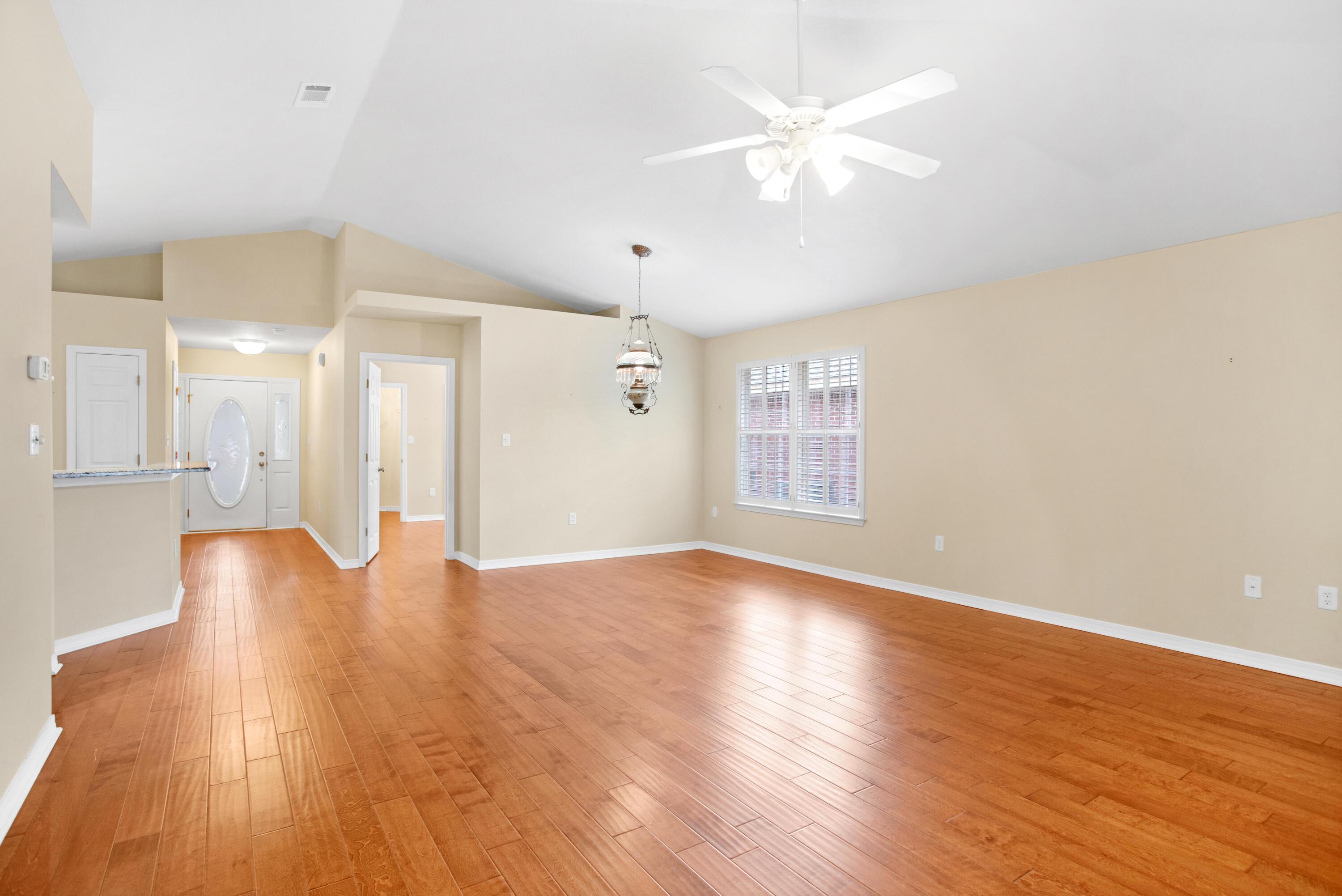 145 Bayou Landing Road Miramar Beach, FL 32550 - Photo 12 of 28 a view of an empty room with wooden floor and a ceiling fan