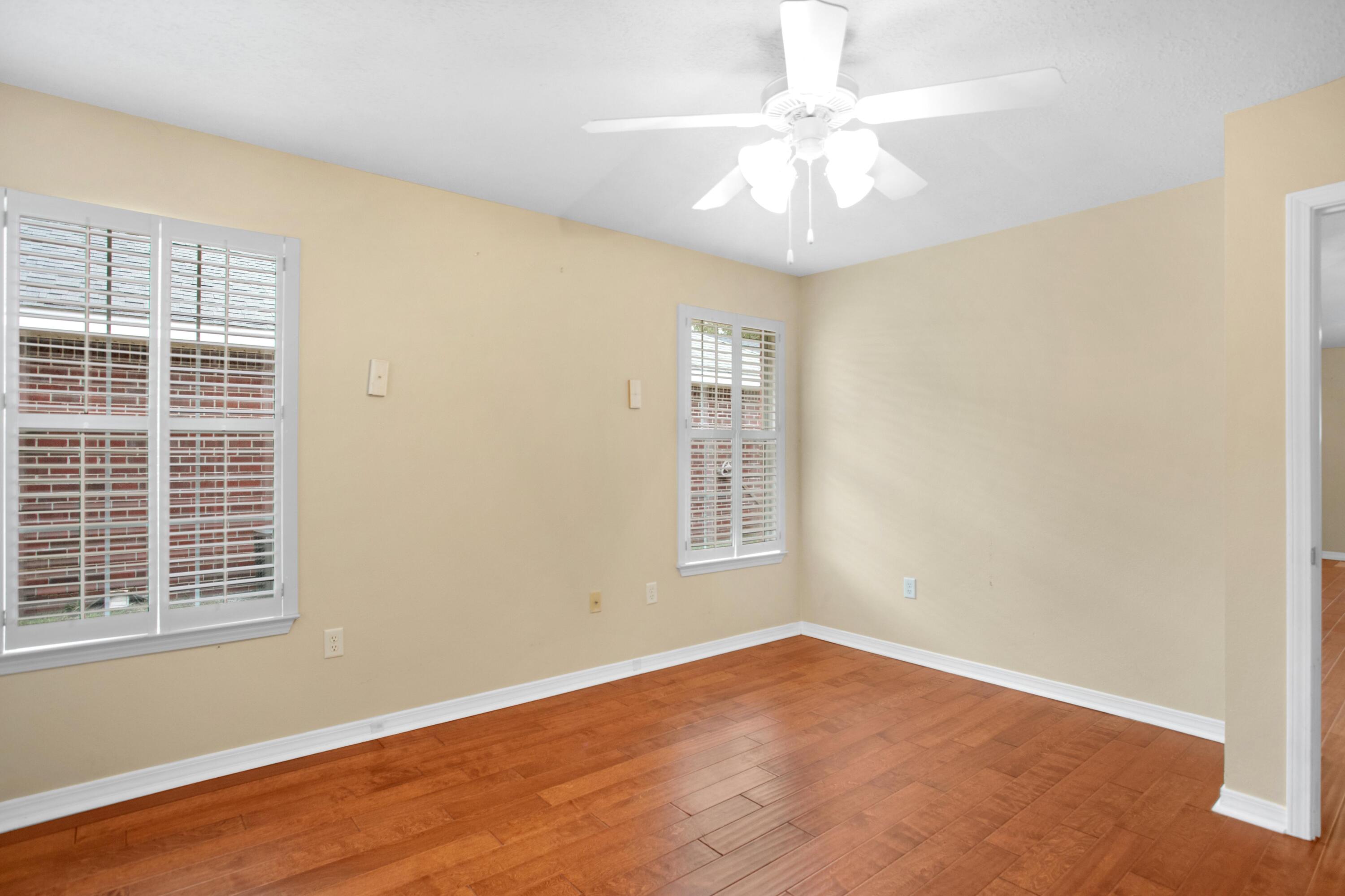 145 Bayou Landing Road Miramar Beach, FL 32550 - Photo 15 of 28 an empty room with windows and chandelier fan