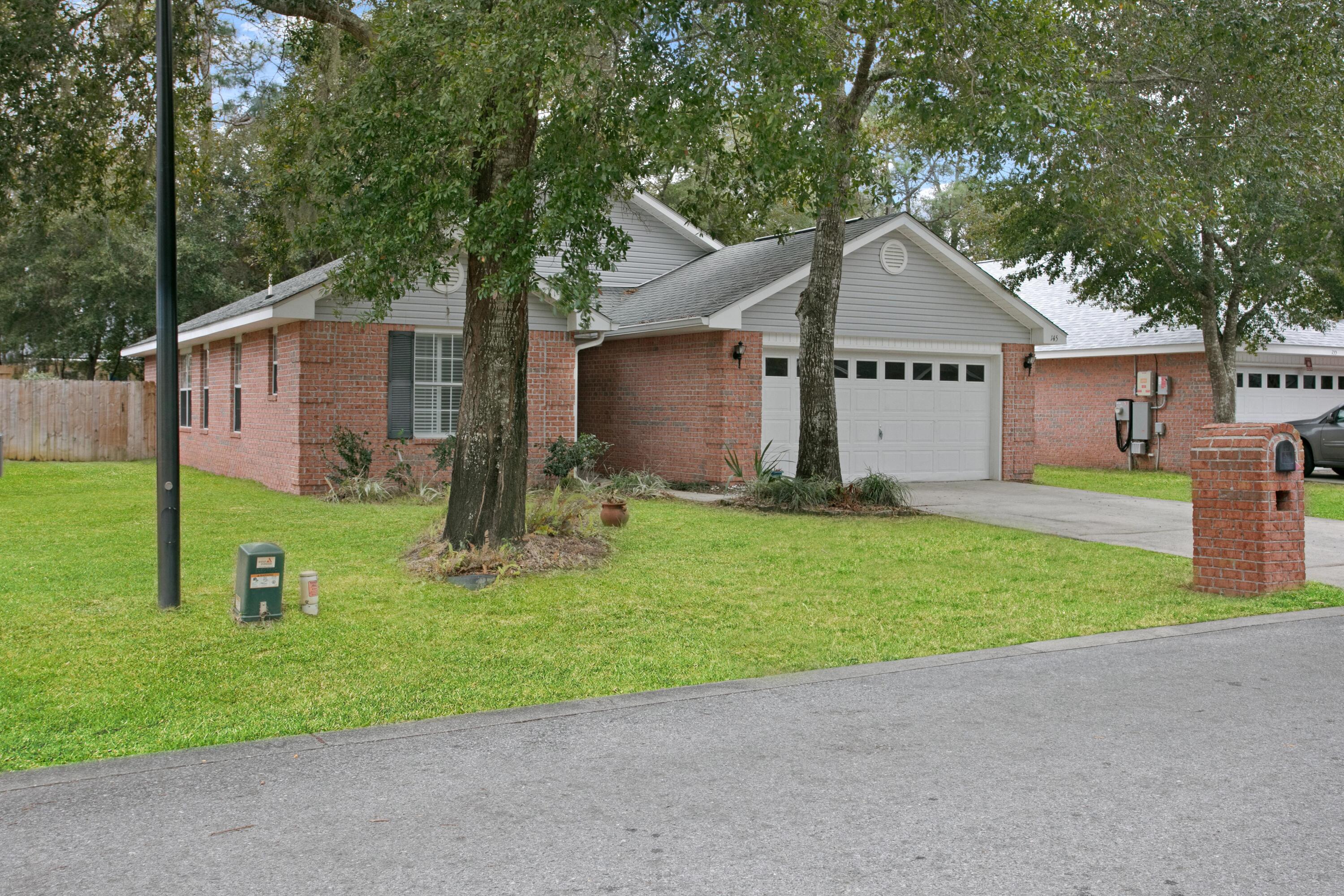 145 Bayou Landing Road Miramar Beach, FL 32550 - Photo 2 of 28 a front view of house with yard and green space
