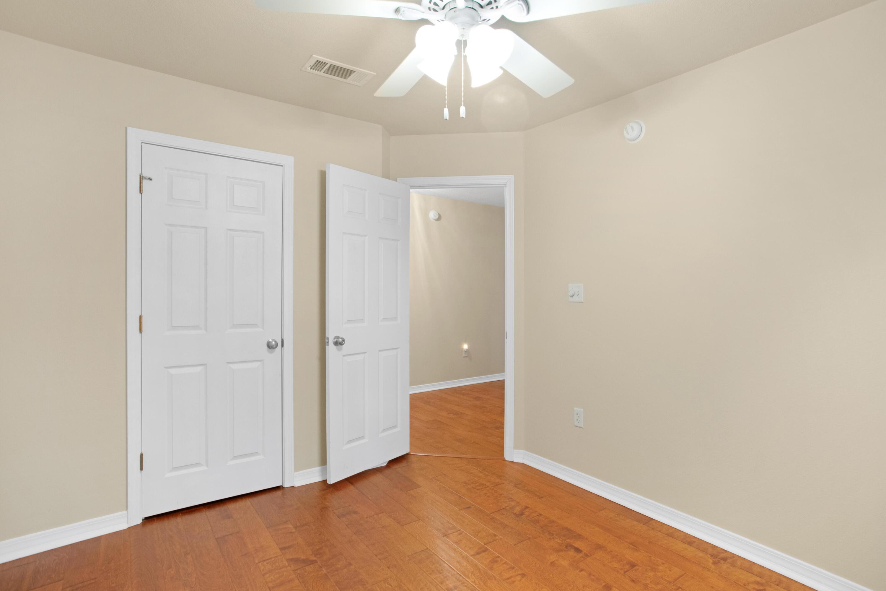 145 Bayou Landing Road Miramar Beach, FL 32550 - Photo 22 of 28 an empty room with a chandelier fan and closet area