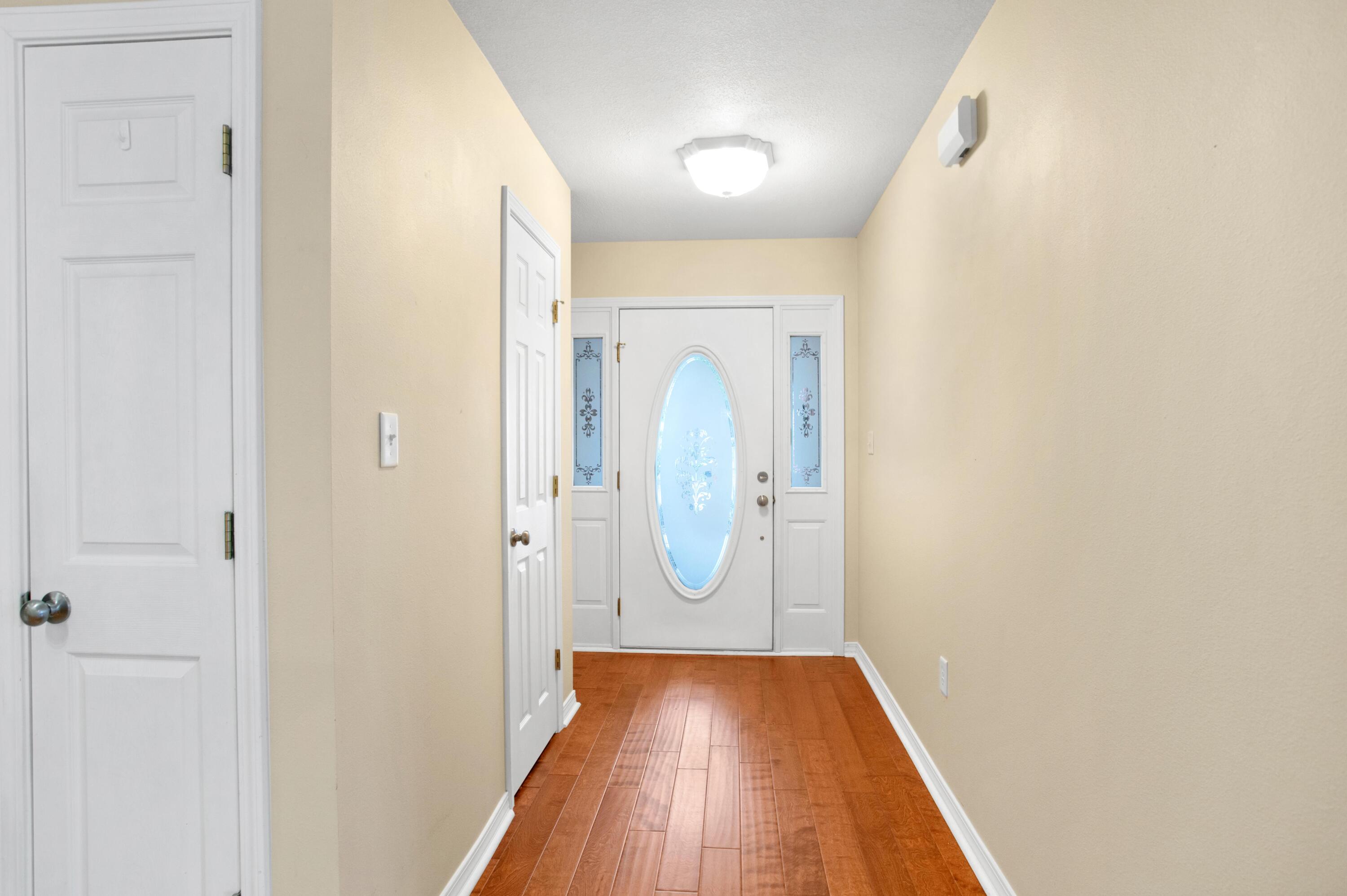 145 Bayou Landing Road Miramar Beach, FL 32550 - Photo 4 of 28 a view of a hallway with wooden floor