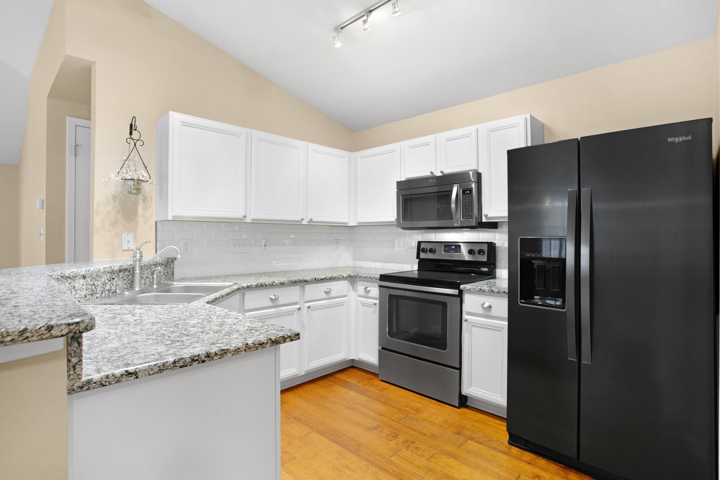 145 Bayou Landing Road Miramar Beach, FL 32550 - Photo 5 of 28 a kitchen with granite countertop a refrigerator stove and sink