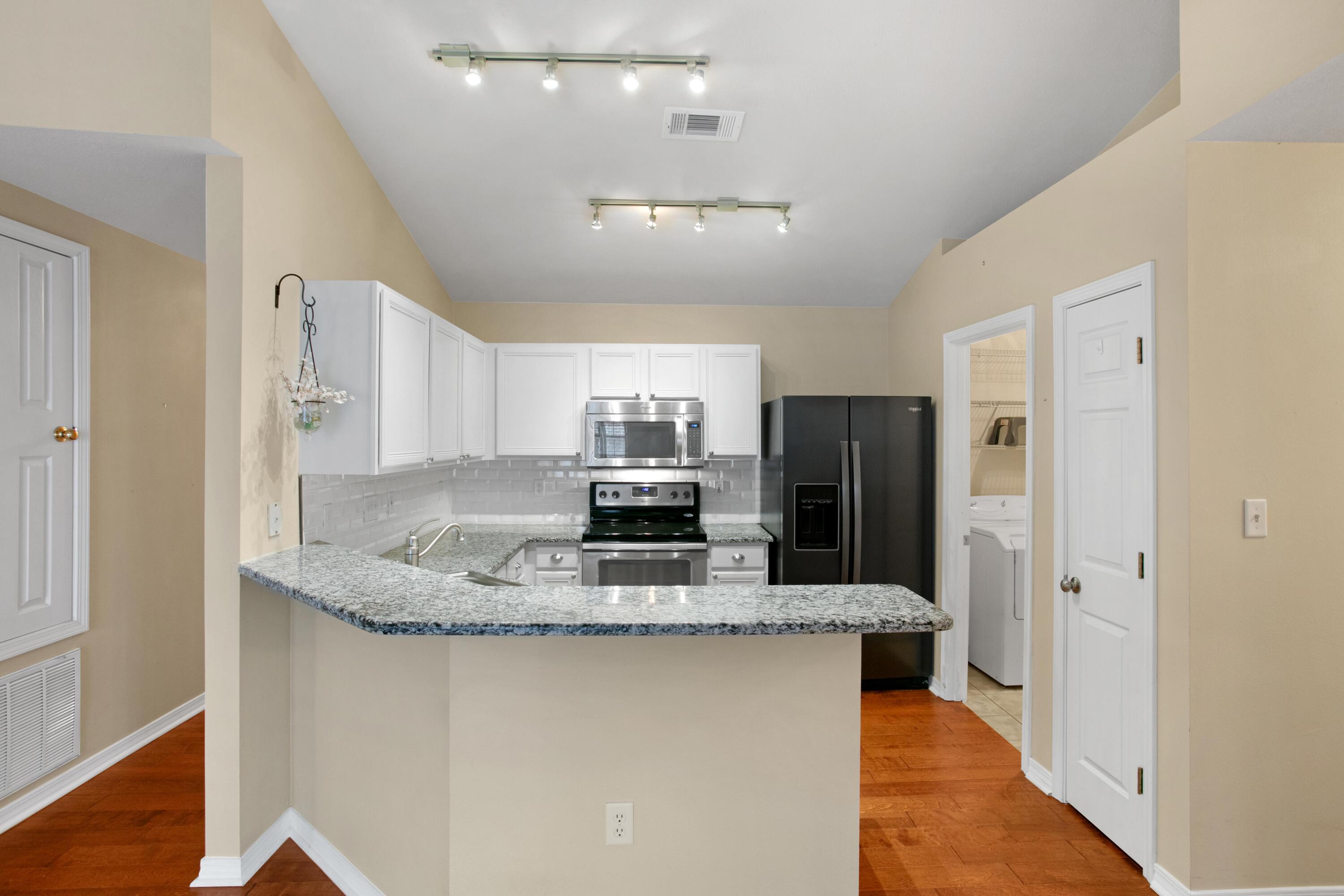 145 Bayou Landing Road Miramar Beach, FL 32550 - Photo 7 of 28 a kitchen with stainless steel appliances granite countertop a refrigerator and a sink