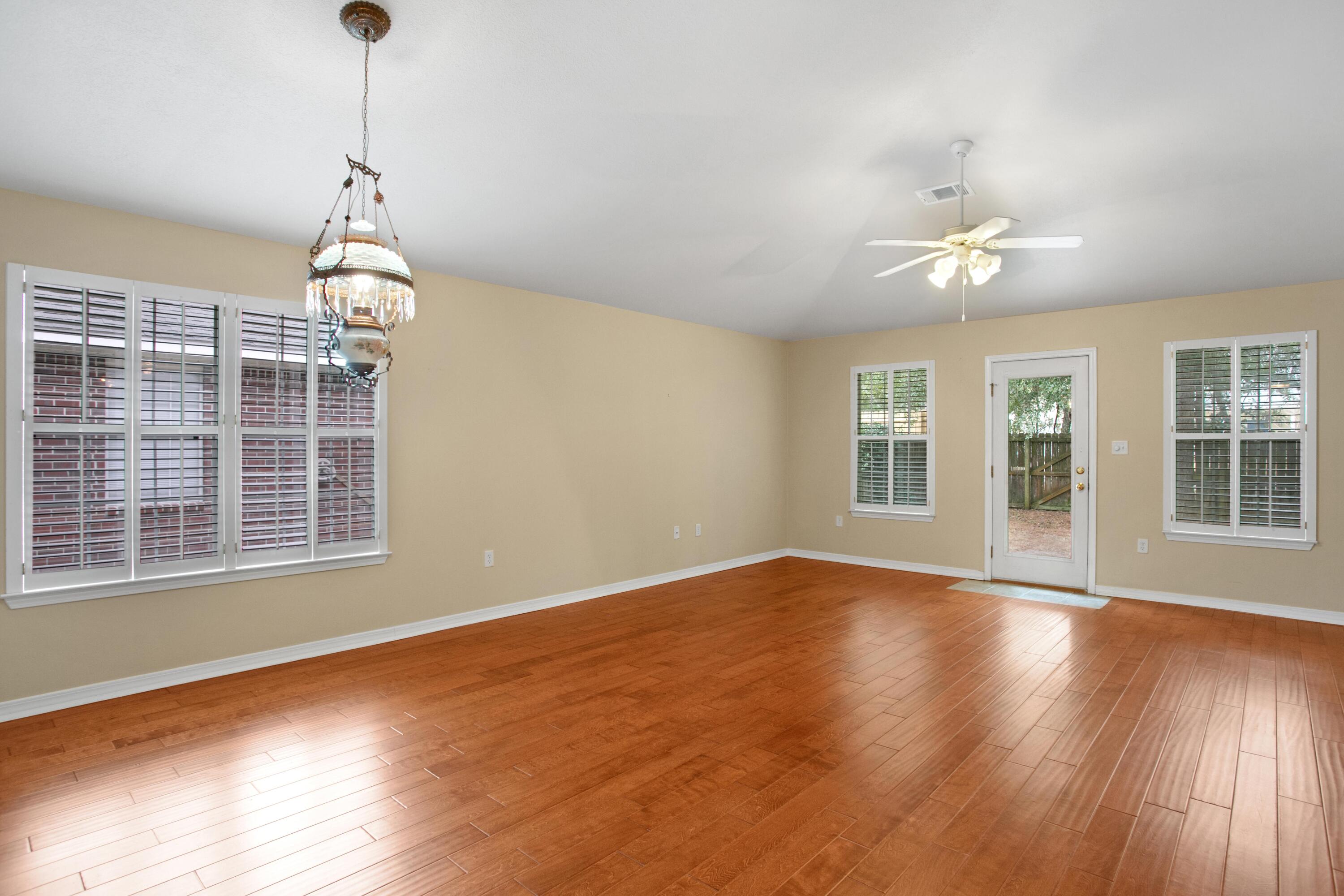 145 Bayou Landing Road Miramar Beach, FL 32550 - Photo 8 of 28 a view of an empty room with wooden floor and a window