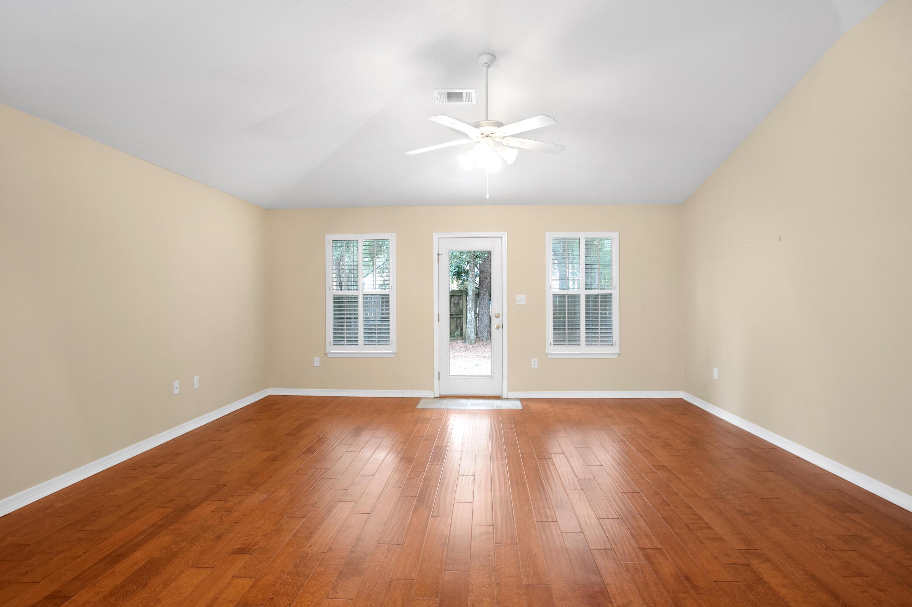 145 Bayou Landing Road Miramar Beach, FL 32550 - Photo 9 of 28 a view of an empty room with wooden floor and a window