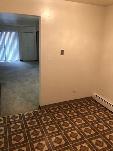 2218 West Nichols Road, Unit C Arlington Heights, IL 60004 - Photo 6 of 10 an empty room with a bench