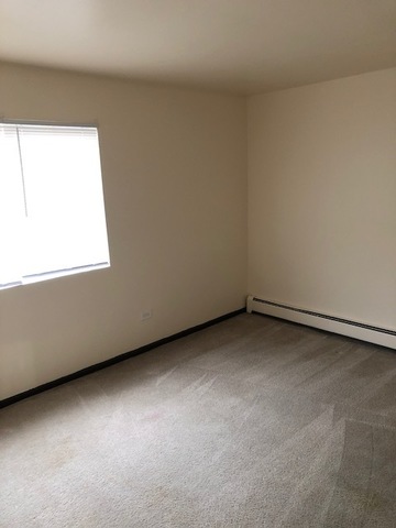2218 West Nichols Road, Unit C Arlington Heights, IL 60004 - Photo 7 of 10 a view of an empty room with a window