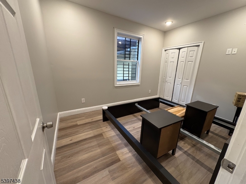 274 Governor Street Paterson, NJ 07501 - Photo 11 of 14 a bedroom with a bed and a window