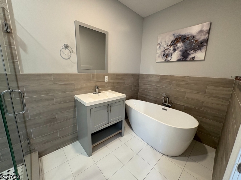 274 Governor Street Paterson, NJ 07501 - Photo 8 of 14 a bathroom with a sink mirror and toilet