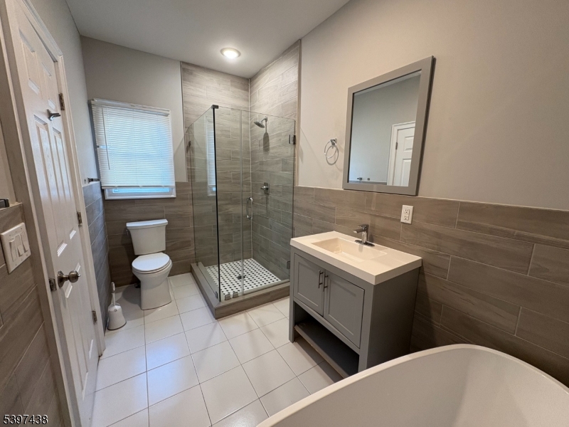 274 Governor Street Paterson, NJ 07501 - Photo 9 of 14 a bathroom with a sink a toilet and a shower